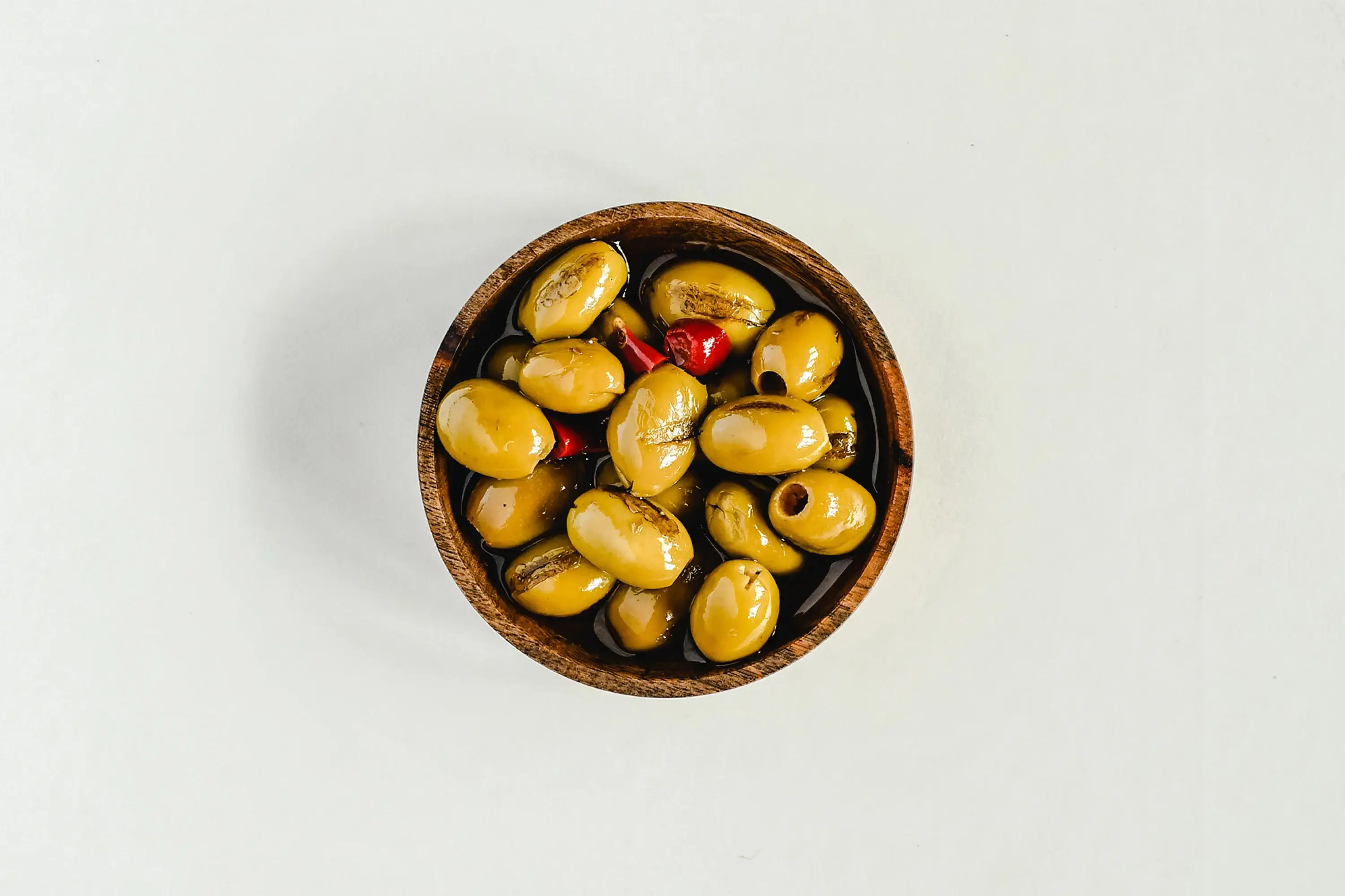 small wooden bowl of olives